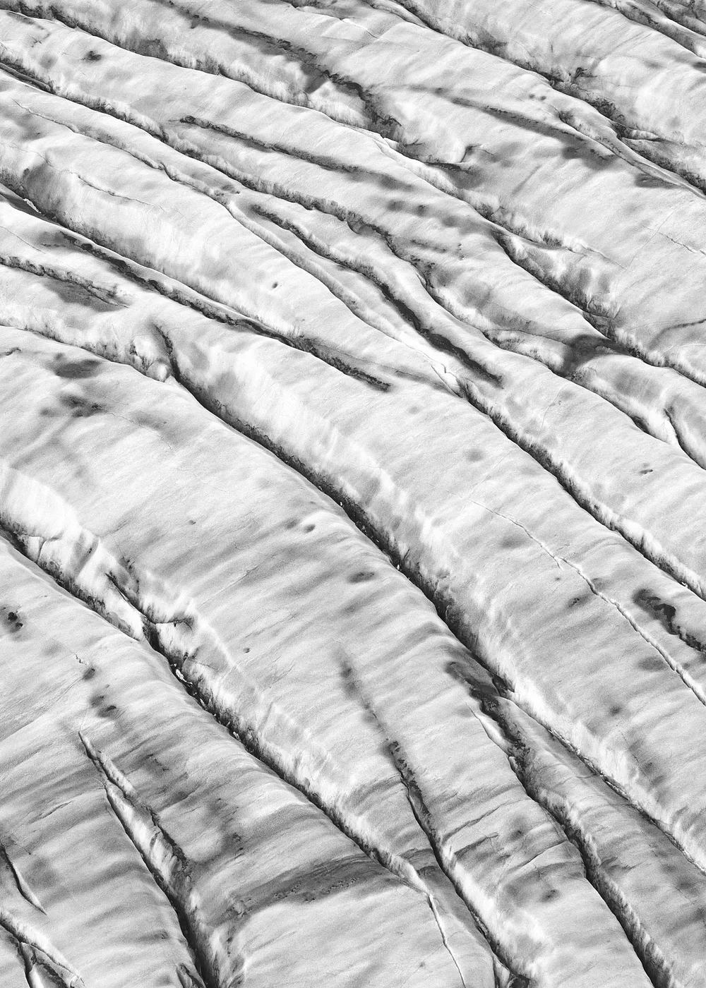 Abstract black and white striations across a glacier near Valdez, Alaska